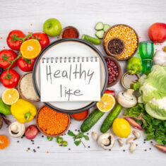 top-view-healthy-life-inscription-spiral-notebook-white-pot-collection-fresh-vegetables-vegetarian-dinner-cooking-white-background